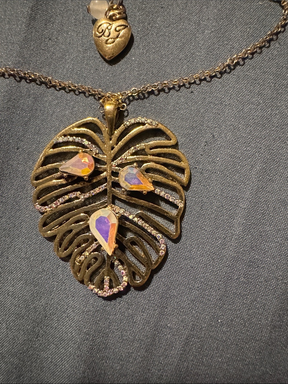 Betsey Johnson Gold Monstera Leaf Necklace with Iridescent Pink-Purple Teardrops - Picture 3 of 3